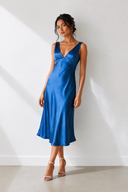 Woman wearing a blue dress against a white background